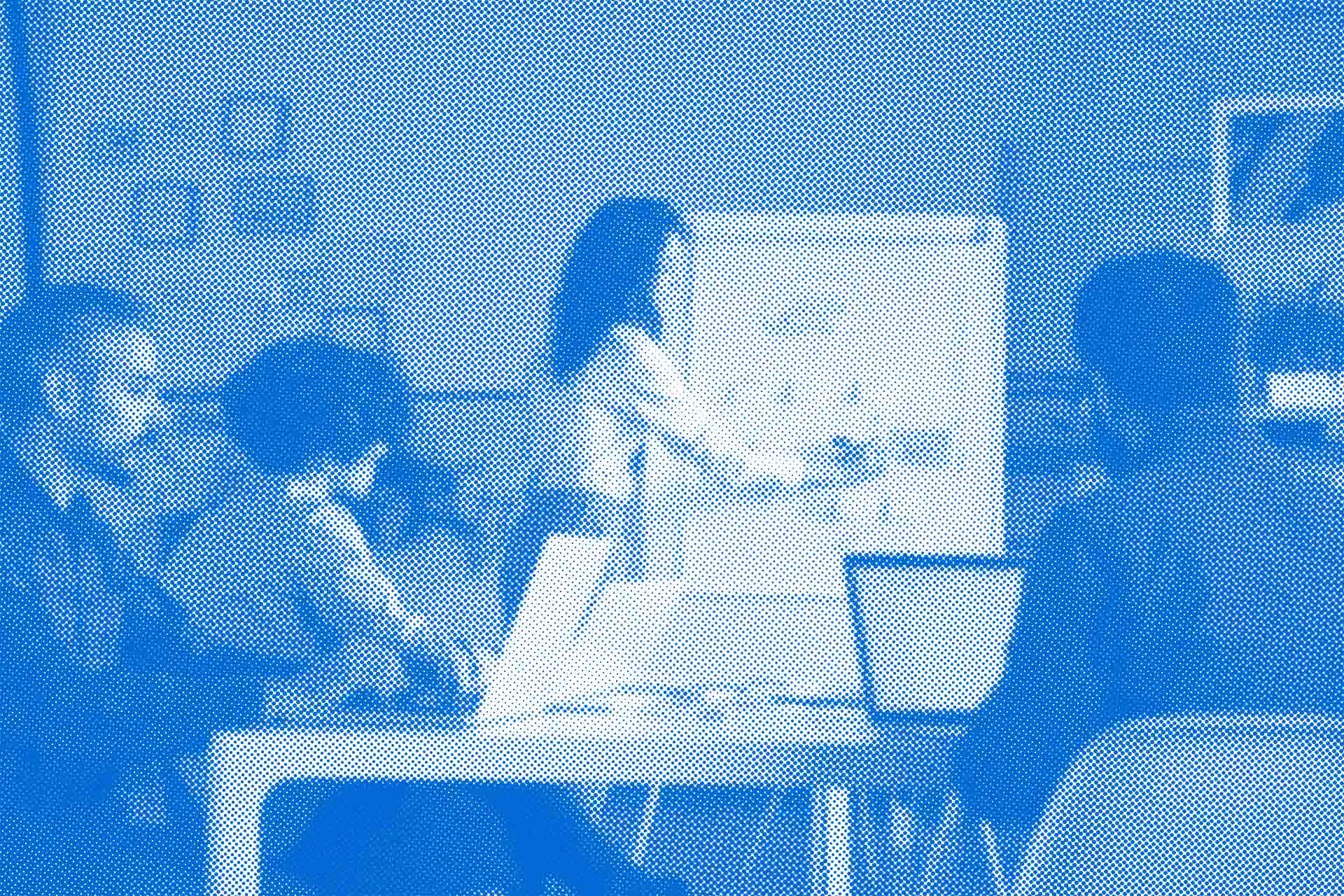 trainer in front of a whiteboard. Students paying attention.